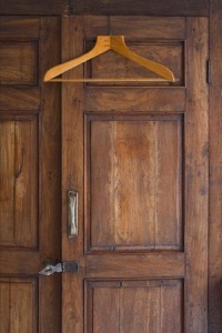 Wooden hanger on door of antique closet