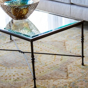 glass coffee table with a bowl as a centerpiece