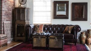 darker leather sofa to match the dark hardwood floor and an Oriental rug